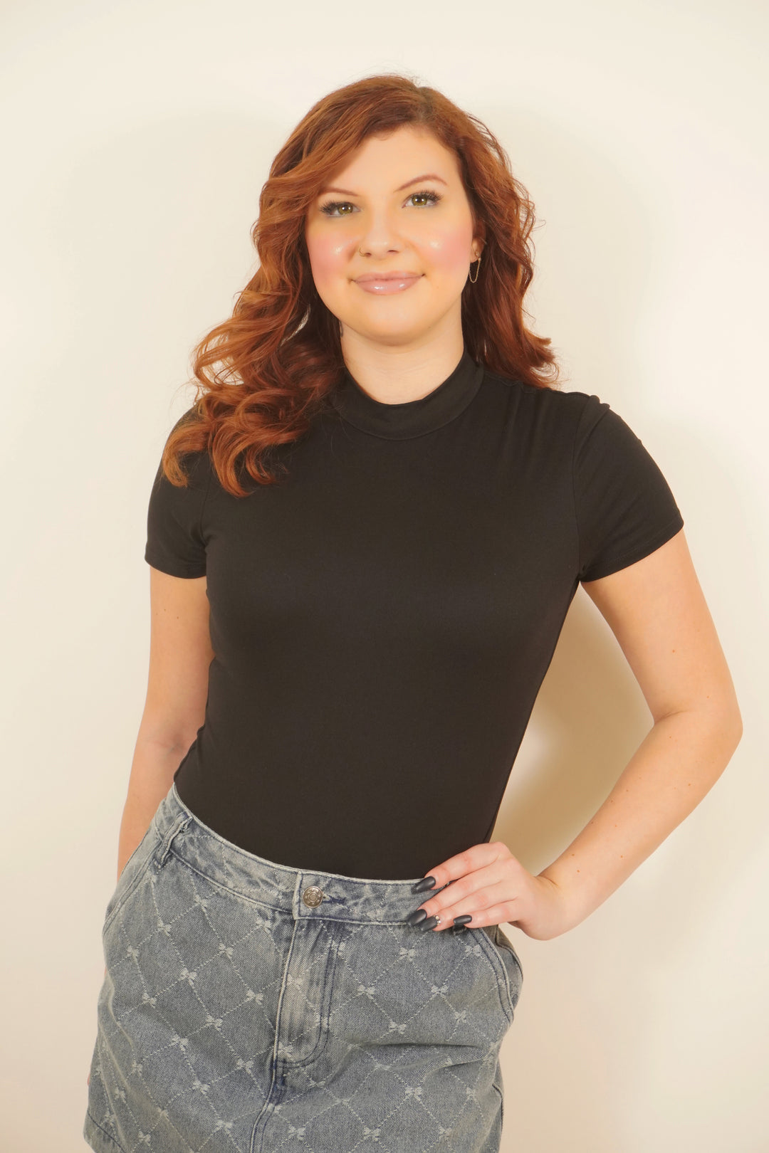 Short-sleeved black bodysuit with a high neckline